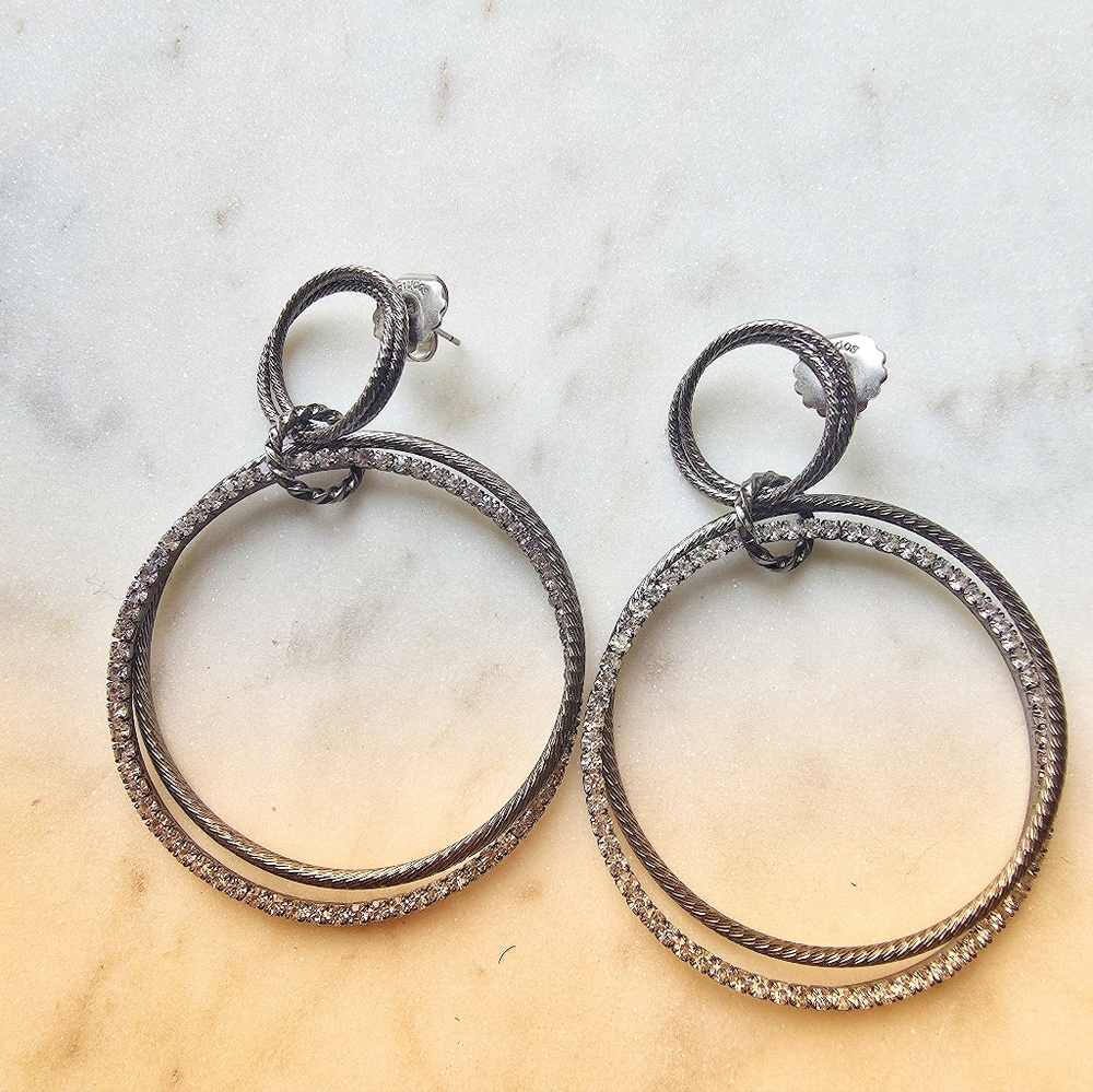 Laila Rowe large gunmetal gray crystal hoop earrings with a post-back closure. 